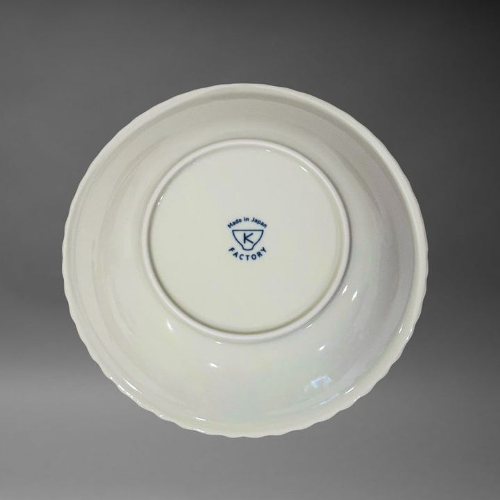 An inverted, bottom-up view of the ceramic bowl, showing the white underside and the blue K Factory 'Made in Japan' mark stamped in the centre.