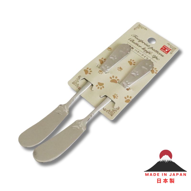 Two butter knives on a decorative card with 'Made in Japan' text and mountain logo.