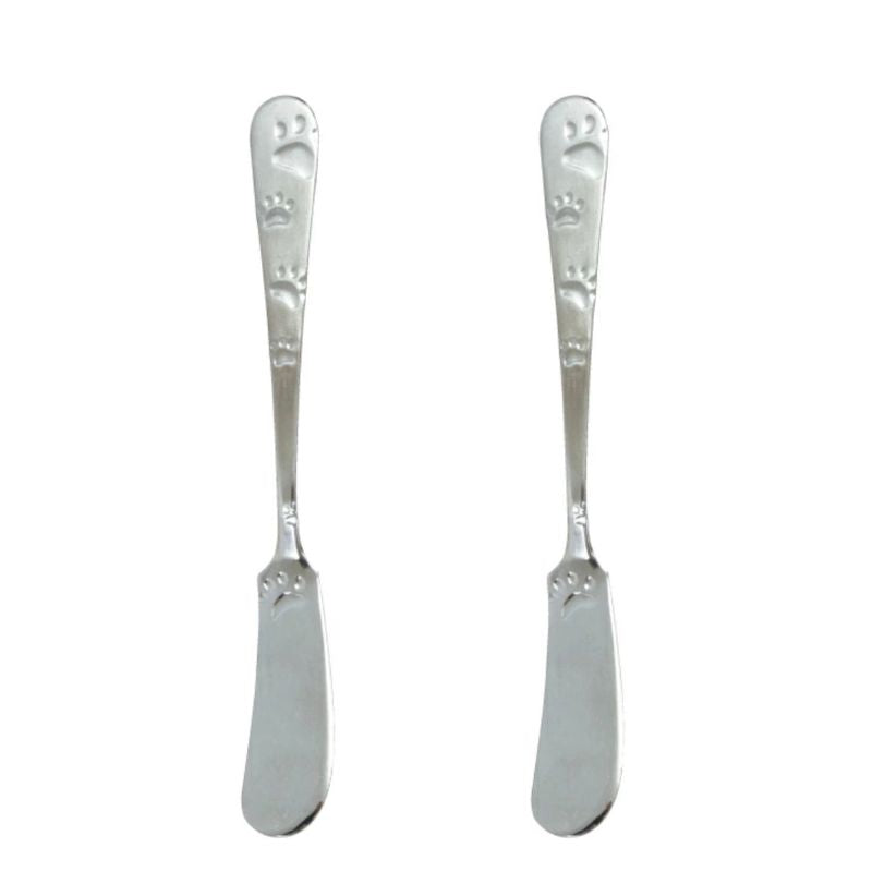 Two silver butter knives with decorative handles on a white background