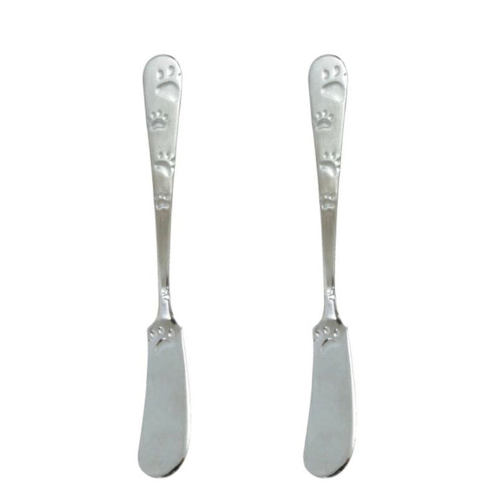 Two silver butter knives with decorative handles on a white background