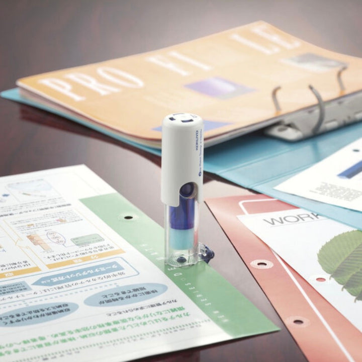 KOKUYO One Patch Stamp on hole-punched documents beside a ring binder