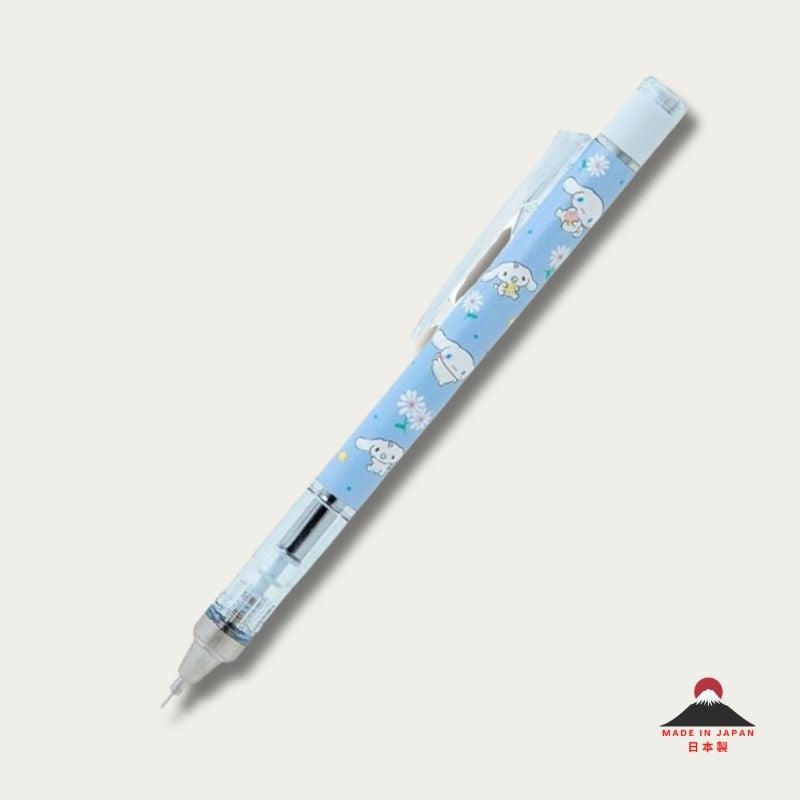 Full-length view of the Tombow Mono Graph x Sanrio Cinnamoroll 0.5mm mechanical pencil, featuring a sky blue barrel adorned with white daisies and Cinnamoroll illustrations, a transparent grip, and a sleek chrome tip.