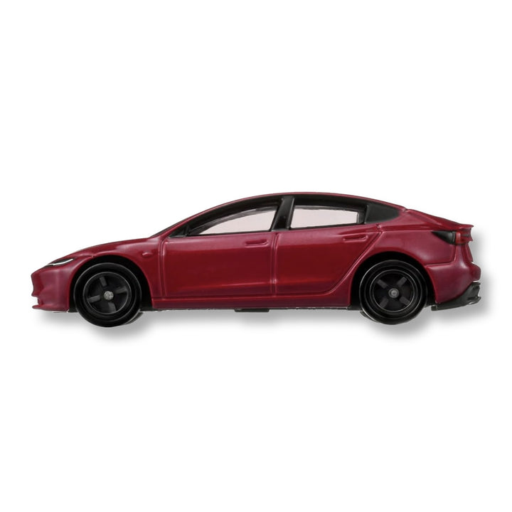 Side profile of the red Tomica No.98 Tesla Model 3 First Edition diecast car with black wheels