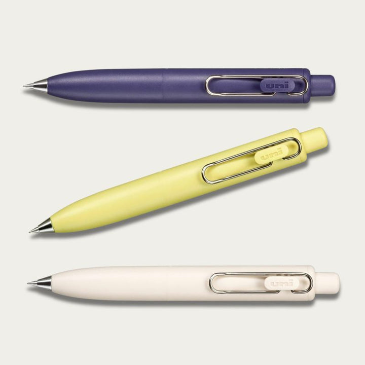 A collection of Uni-ball One P gel pens in Yellow,  Purple, and Cream; compact aesthetic Japanese pens for everyday carry.