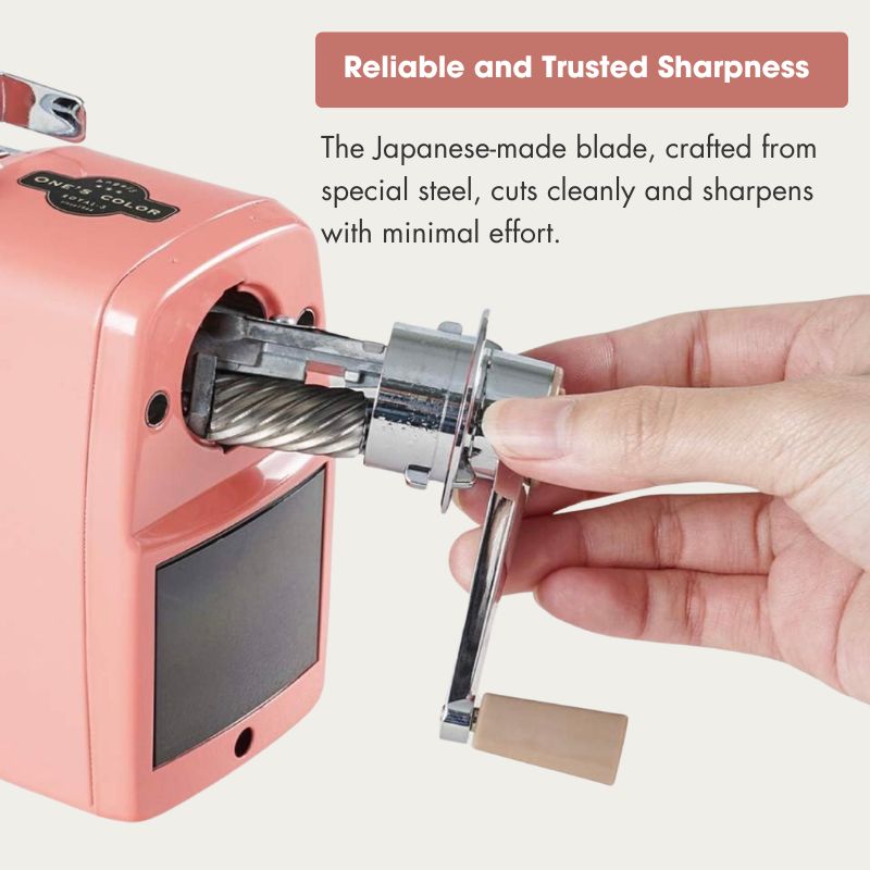 A hand operating a pink manual cable sharpener with a metal sharpening wheel, accompanied by promotional text highlighting its Japanese-made steel blade and reliable sharpness.