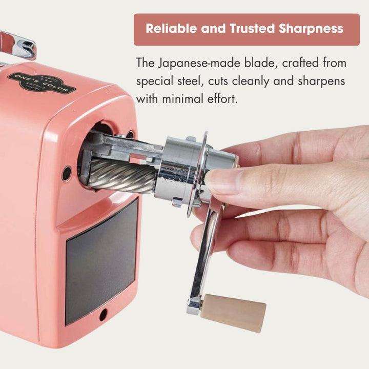 A hand operating a pink manual cable sharpener with a metal sharpening wheel, accompanied by promotional text highlighting its Japanese-made steel blade and reliable sharpness.