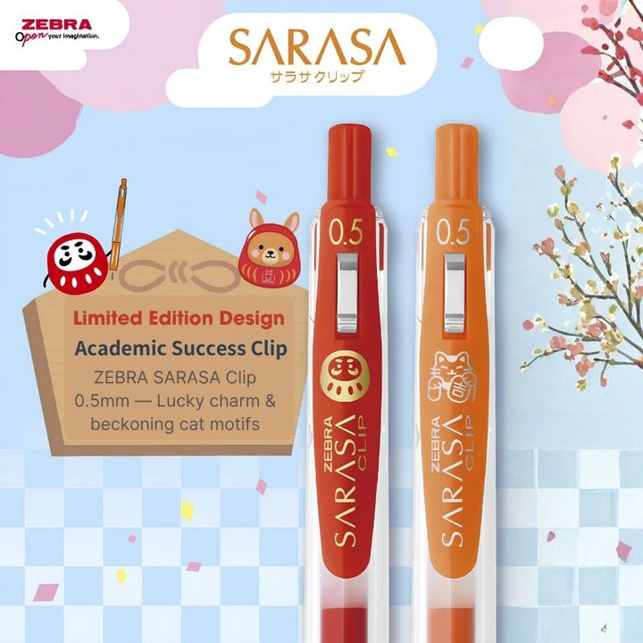 Two Zebra Sarasa clip pens in limited edition Lucky Charm and Beckoning Cat colors, displayed on a light blue and pink themed background with Japanese illustrations.