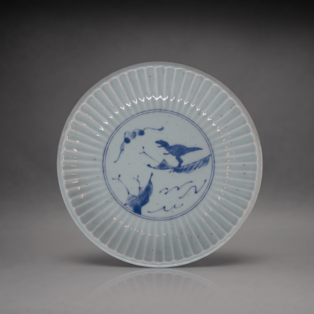 Edokko Dinosaur shinogi side plate 15.5cm in celadon glaze with blue T-rex riding a leaf over waves, Mino ware made in Japan