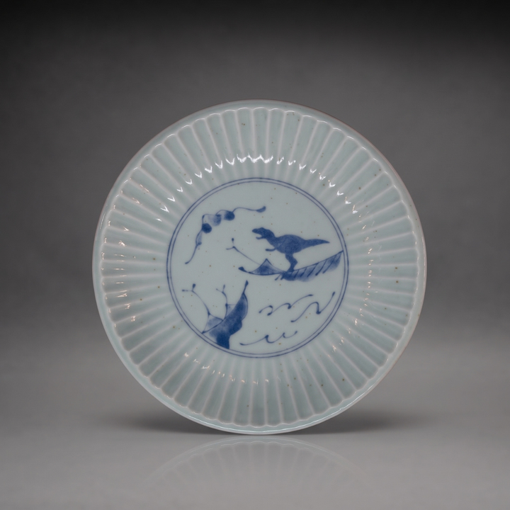 Edokko Dinosaur shinogi side plate 15.5cm in celadon glaze with blue T-rex riding a leaf over waves, Mino ware made in Japan