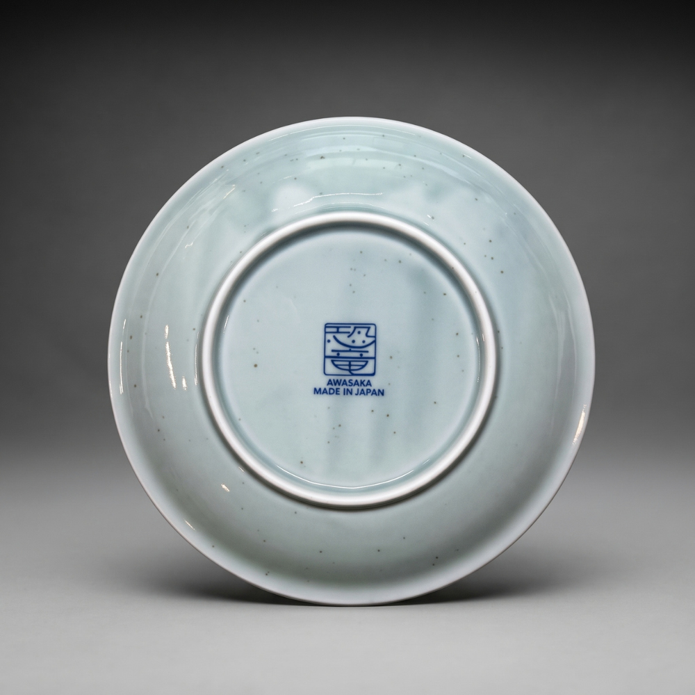 Back of Edokko Dinosaur side plate showing AWASAKA Made in Japan back stamp and natural iron speckles in the celadon glaze