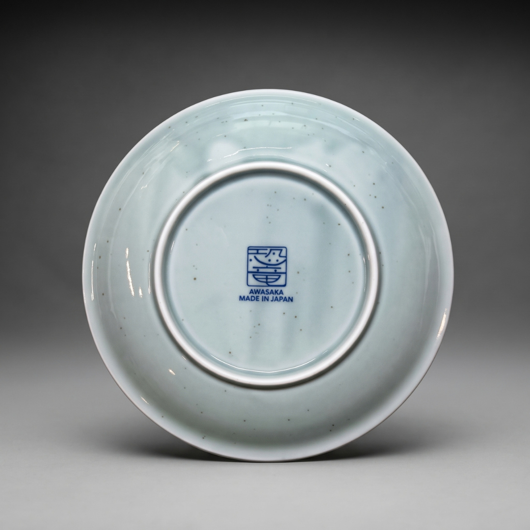 Back of Edokko Dinosaur side plate showing AWASAKA Made in Japan back stamp and natural iron speckles in the celadon glaze