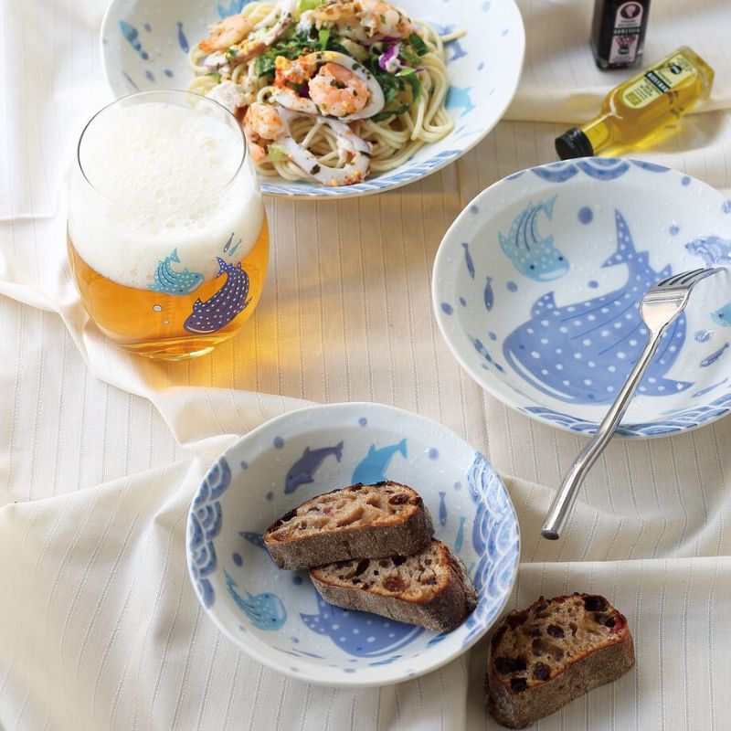 Jinbei Namama Usui glass filled with cold beer alongside whale shark ceramic bowls — Japanese ocean table setting