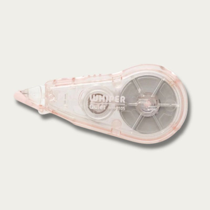 A Whimper Quiet WM2105 correction tape dispenser in a translucent pale pink and clear plastic casing, shown on a light gray background.