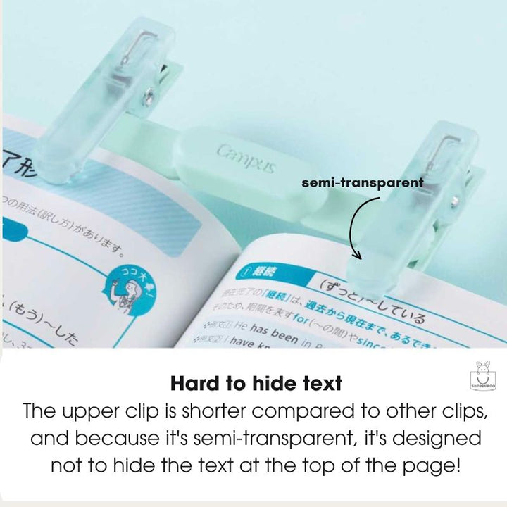 Two translucent pale green book clips holding an open book, with text labels reading &
