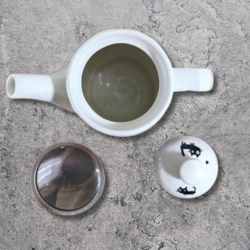 Top view showing lid and stainless steel strainer of Mino-yaki Black Cats Teapot, Japan.