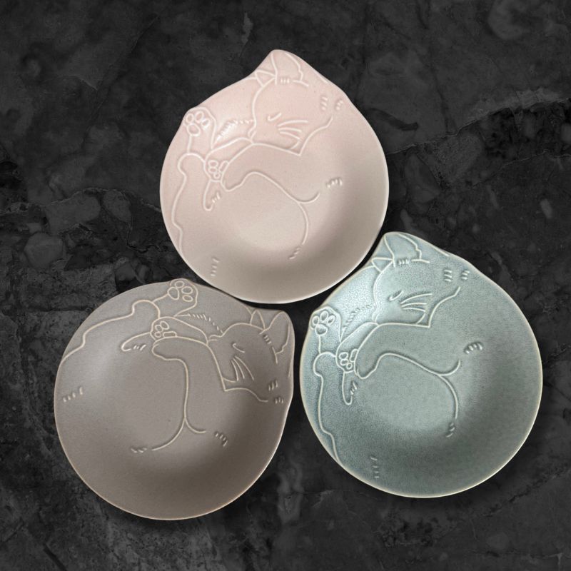 Set of three Miau Cat Nyanmonite plates in Sakura Pink, Salt Grey, and Ice Mint displayed on dark stone background.