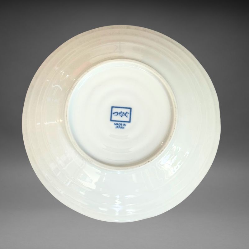 An inverted, bottom-up view of the white ceramic plate, showing the curved sides and the blue 'つなぐ MADE IN JAPAN' mark stamped in the centre of the base.