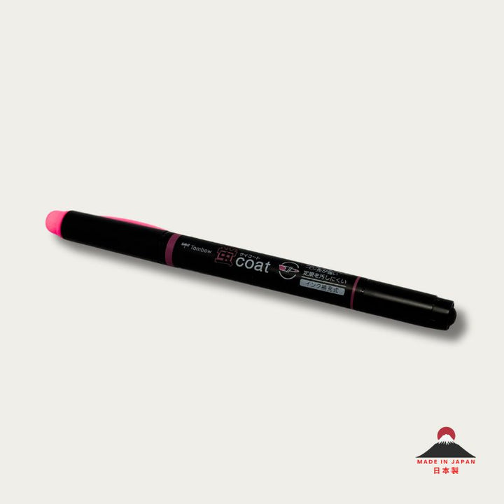 A high-resolution product shot of a single Tombow Kei Coat highlighter in pink. The black pen body features the "蛍coat" logo and icons indicating its reinforced nib and refillable ink system.