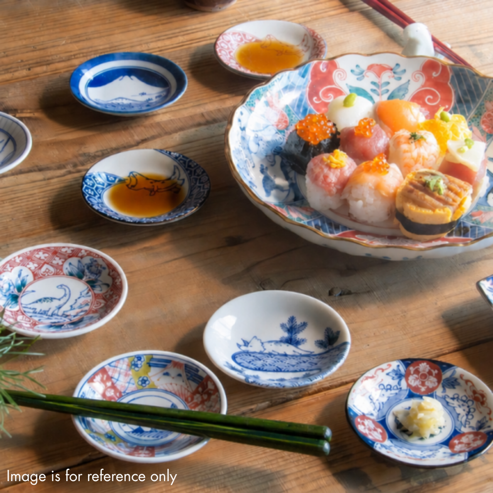 Edokko Dinosaur mame plates used as soy sauce and pickle dishes beside a platter of temari sushi on a wooden table